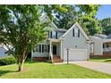 Two-story home with light-blue siding, a two-car garage, and a well-maintained lawn at 2409 Horizon Hike Ct, Raleigh, NC 27603