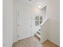 Bright entryway features a white door and carpeted stairs at 285 Plaza Dr # C, Chapel Hill, NC 27517