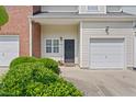 Exterior view featuring attached garage and brick accents at 285 Plaza Dr # C, Chapel Hill, NC 27517