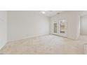 Spacious living room with carpet flooring and glass patio doors at 285 Plaza Dr # C, Chapel Hill, NC 27517