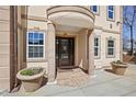 Close up view of building entrance featuring stone columns, manicured plants and an elegant front door at 318 W Lillington St, Angier, NC 27501