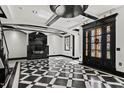 Elegant living area boasts a modern fireplace, checkered floors, and black trim highlighting the open design at 318 W Lillington St, Angier, NC 27501