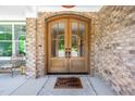 Beautiful arched double front doors with glass panes and brick surround at 386 Monteith Dr, Chapel Hill, NC 27516