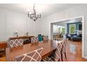 Elegant dining room with hardwood floors, stylish chandelier, and open access to the living area at 395 Timberlands Dr, Louisburg, NC 27549