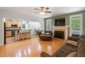 Comfortable living room with fireplace, hardwood floors, and open layout to the kitchen and dining area at 395 Timberlands Dr, Louisburg, NC 27549
