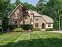An inviting stone home with lush green lawn and manicured landscaping at 410 Mountain Laurel, Chapel Hill, NC 27517