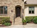 Charming home entrance with stone steps and meticulously landscaped bushes at 410 Mountain Laurel, Chapel Hill, NC 27517