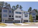 View of the front exterior of the homes showcasing multiple garage doors and modern architecture at 4502 Mint Leaf Lane Ln, Raleigh, NC 27612