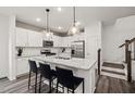 This modern kitchen features stainless steel appliances, granite countertops, and an island with barstool seating at 5000 Reader Way, Durham, NC 27703