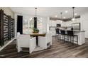 Open floor plan dining room with a round table, wine rack and pendant lighting fixtures at 5010 Reader Way, Durham, NC 27703