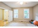 Cozy bedroom with carpet, natural light, and a doorway at 508 E Hatterleigh Ave, Hillsborough, NC 27278