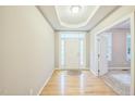 Bright entryway features hardwood floors, transom window, and door with sidelights at 508 E Hatterleigh Ave, Hillsborough, NC 27278