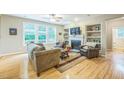 Inviting living room with hardwood floors, built-in shelves, and comfortable seating at 508 E Hatterleigh Ave, Hillsborough, NC 27278