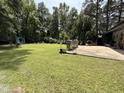 Expansive backyard featuring a well-maintained lawn and patio, ideal for outdoor living at 509 Forest Ridge Rd, Garner, NC 27529