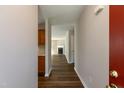 View from the entryway showcasing wood floors and a glimpse into the living room and kitchen at 518 S Coalport Dr, Apex, NC 27502