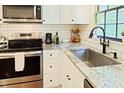 Bright kitchen featuring stainless appliances, subway tile backsplash, and light countertops at 5304 Cypress Ln, Raleigh, NC 27609