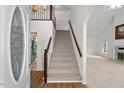 Bright entryway showcasing a staircase, chandelier, hardwood and carpet flooring at 6321 Malvern Ln, Hillsborough, NC 27278