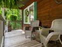 Relaxing porch with wicker chairs, perfect for enjoying the surrounding greenery and peaceful atmosphere at 6760 Keansburg Rd, Gibsonville, NC 27249