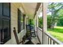 Inviting front porch with classic rocking chairs, perfect for enjoying the outdoors and relaxing at 7021 Oviedo Dr, Raleigh, NC 27603