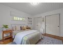 Cozy bedroom with hardwood floors, two closets, and a comfortable bed accented by decorative pillows and a patterned rug at 7042 Us 401 Highway N, Fuquay Varina, NC 27526