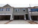 New townhome construction featuring an attached garage and horizontal siding at 7104 Hubner Pl # 45, Cary, NC 27519