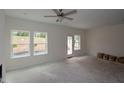 Living room with a ceiling fan, recessed lighting, and access to the outdoors at 7104 Hubner Pl # 45, Cary, NC 27519