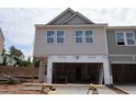 New two-story home exterior with light gray siding and a spacious two-car garage at 7106 Hubner Pl # 44, Cary, NC 27519