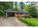 Inviting single-story brick home with a practical carport and a well-maintained front lawn at 720 Sherrybrook Dr, Raleigh, NC 27610