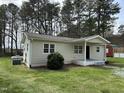 Single-story home showcasing a well-maintained lawn, clean siding, and efficient propane tank at 726 Thompson St, Pittsboro, NC 27312