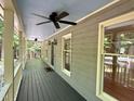 Spacious covered front porch with ceiling fans and views of the wooded surroundings at 8116 Reynard Rd, Chapel Hill, NC 27516