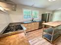 Modern kitchen features stainless steel appliances and light wood cabinetry at 8116 Reynard Rd, Chapel Hill, NC 27516