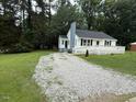 Desirable home showcasing fresh gravel driveway and well-maintained landscaping at 902 Roanoke Ave, Henderson, NC 27536