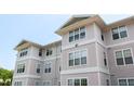Exterior of three story apartment building with beige siding and white trim at 929 Morreene Rd # C31, Durham, NC 27705