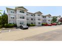 Three story apartment building with beige siding and parking lot with several cars at 929 Morreene Rd # C31, Durham, NC 27705