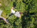 Aerial shot of a home nestled among lush, mature trees at 106 Wolfs Trl, Chapel Hill, NC 27516