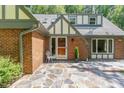 Inviting brick home entrance featuring stone patio at 106 Wolfs Trl, Chapel Hill, NC 27516