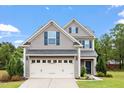Charming two-story home with gray siding, blue shutters, two-car garage and lovely landscaping at 108 White Burley Ct, Durham, NC 27703