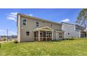 Backyard featuring a screened in patio, and a spacious well manicured lawn at 1100 Balsawood Dr # 5, Durham, NC 27705