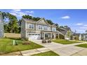 Exterior elevation featuring well-manicured lawn and an attached two car garage at 1100 Balsawood Dr # 5, Durham, NC 27705