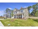 Beautifully landscaped front yard, covered front porch and manicured green lawn at 1100 Balsawood Dr # 5, Durham, NC 27705