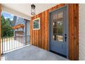 Charming front porch with wood paneling, stone accents, and metal railing at 120 Pilot Ridge Rd, Zebulon, NC 27597
