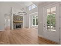 Bright living room featuring a stone fireplace, hardwood floors, and ample natural light at 120 Pilot Ridge Rd, Zebulon, NC 27597