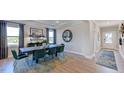 Bright dining area with elegant table set, large windows, and sophisticated decor at 1201 Michelle Mist Way, Apex, NC 27523