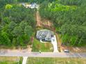 Expansive aerial view of a traditionally styled house with an extensive lawn and surrounded by lush trees at 1212 Perry Bluff Dr, Wake Forest, NC 27587