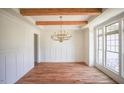 Bright dining room with wood floors, decorative wood beams, and a chandelier at 1212 Perry Bluff Dr, Wake Forest, NC 27587
