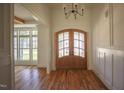 Elegant foyer with hardwood floors, wainscoting, and a double-door entrance at 1212 Perry Bluff Dr, Wake Forest, NC 27587