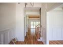Hallway featuring hardwood floors and a view of the stairway and living area at 1212 Perry Bluff Dr, Wake Forest, NC 27587