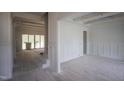 Interior view of rooms with fresh white paint and unfinished wood beams, partially covered with protective plastic at 1212 Perry Bluff Dr, Wake Forest, NC 27587