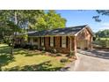 Brick home featuring an attached garage, well-manicured landscaping, and a welcoming facade at 129 Castle Dr, Smithfield, NC 27577