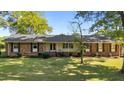 Charming brick ranch home with a lush front lawn and well-maintained landscaping offers great curb appeal at 129 Castle Dr, Smithfield, NC 27577